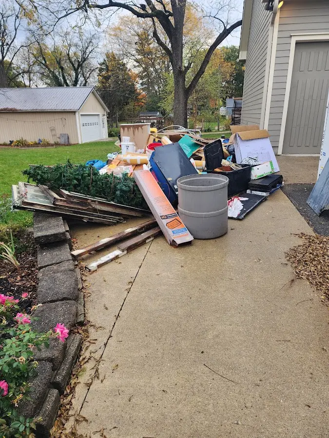Dumpster being loaded with debris for Commercial Dumpster Rental in Grinnell